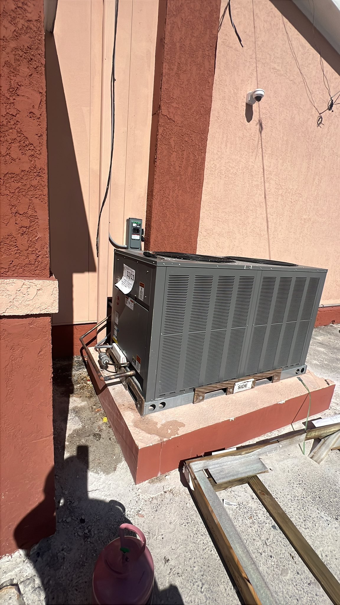 Commercial AC condensing unit installed outside Nassau building